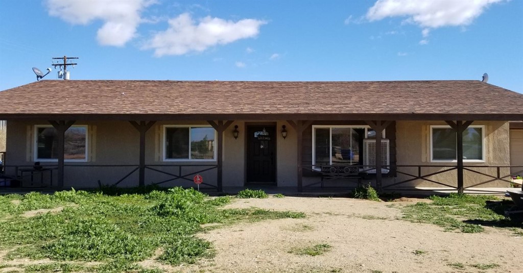 13777 Olema Road Apple Valley, CA 92307 - Photo 1 of 1 a front view of a house with garden