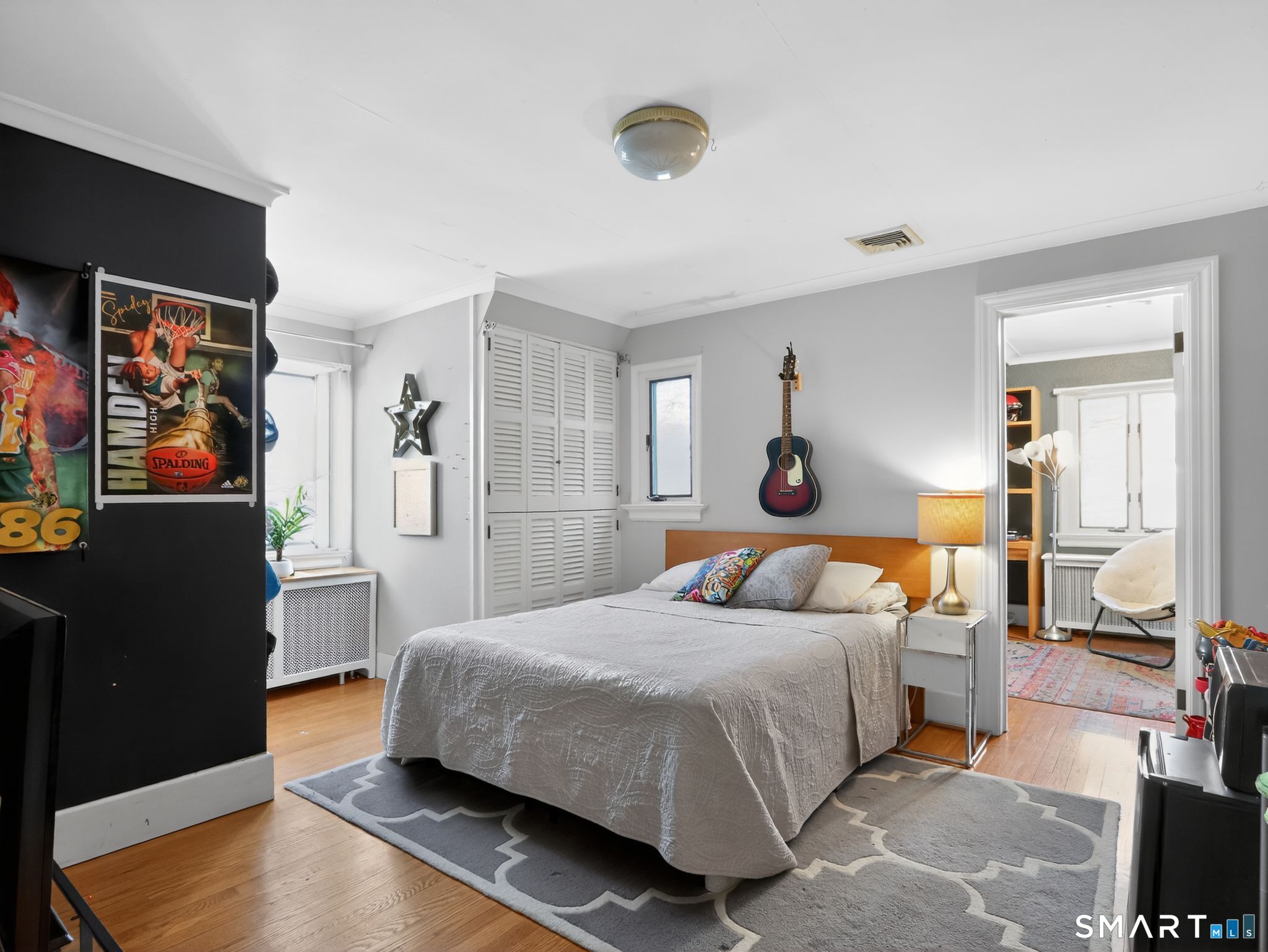 59 Broadfield Road Hamden, CT 06517 - Photo 15 of 40 a bedroom with a bed and wooden floor