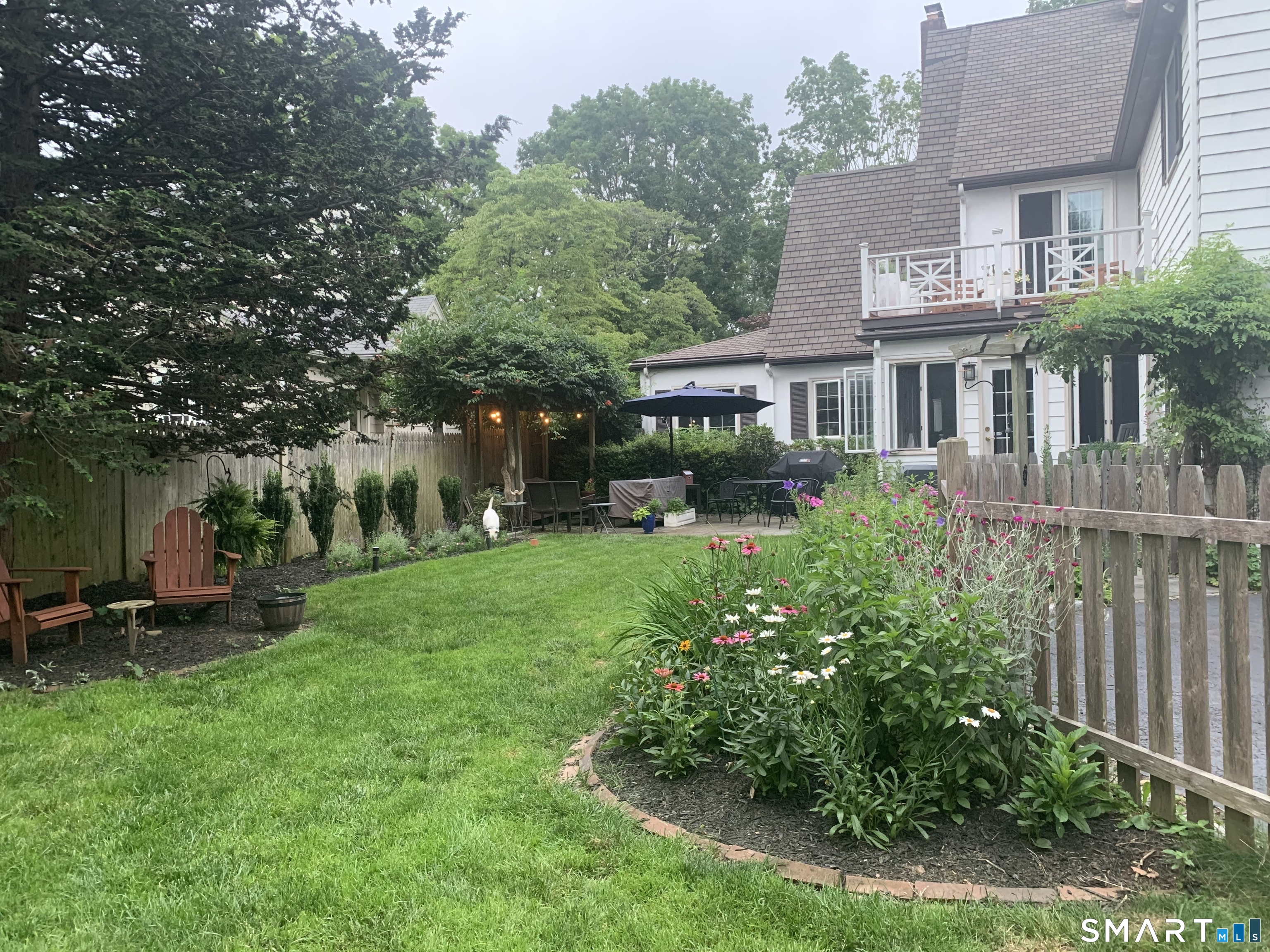 59 Broadfield Road Hamden, CT 06517 - Photo 34 of 40 a aerial view of a house with a yard table and chairs