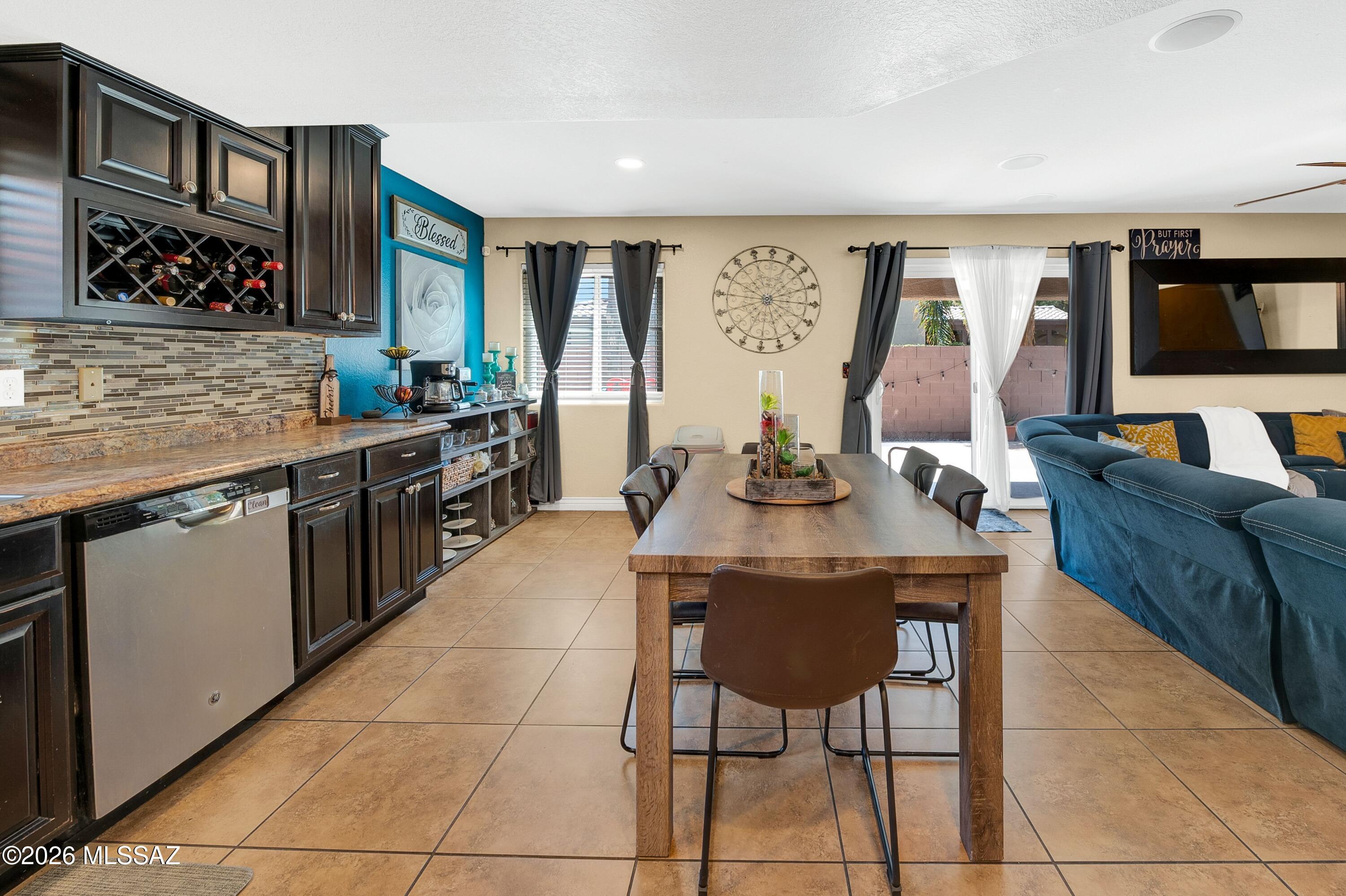 7159 West Maple Ridge Drive Tucson, AZ 85743 - Photo 14 of 42 a kitchen with stainless steel appliances granite countertop a stove top oven a sink dishwasher and cabinets with wooden floor
