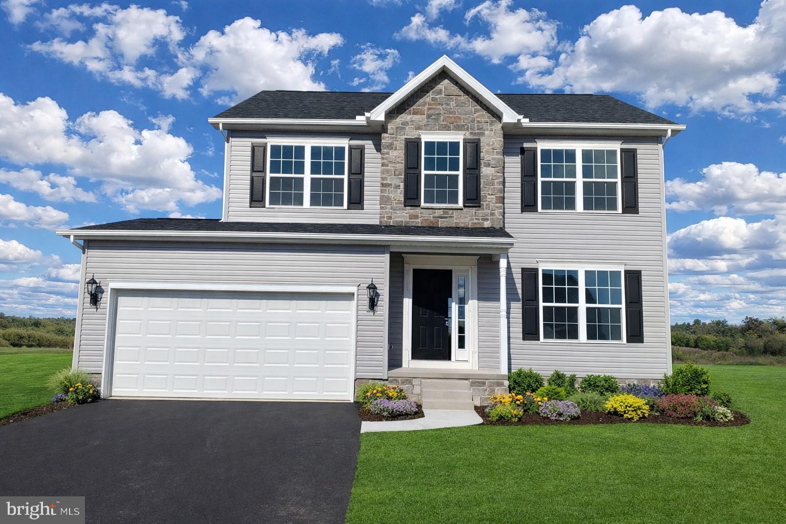 a front view of a house with a garden and plants