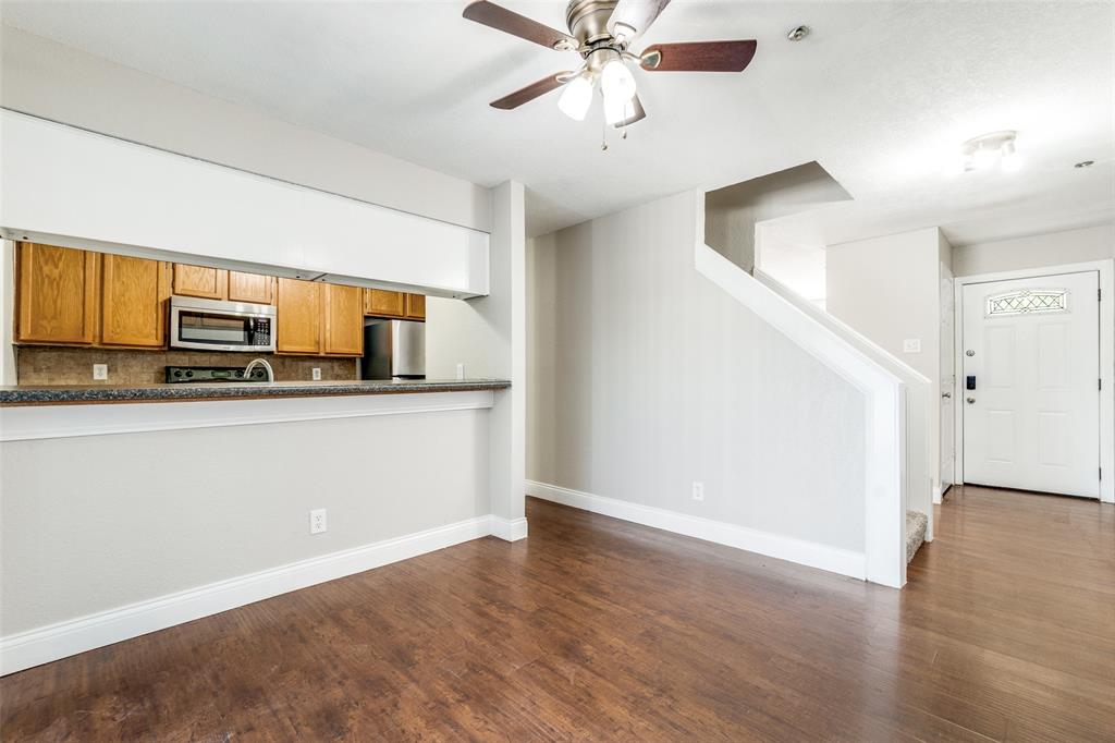 a kitchen with stainless steel appliances a refrigerator and a microwave