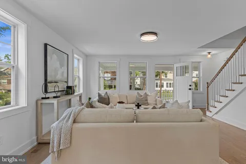 a view of a livingroom with furniture and stairs