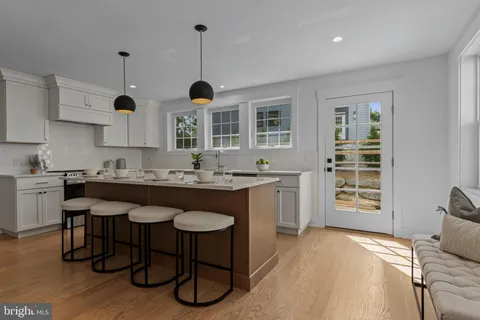 a view of a hallway with wooden floor and closet area