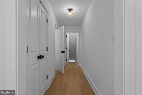 a bathroom with a granite countertop sink a mirror and a shower