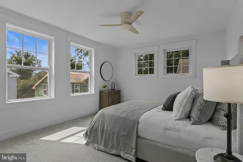 a picture of a bench in front of a white house