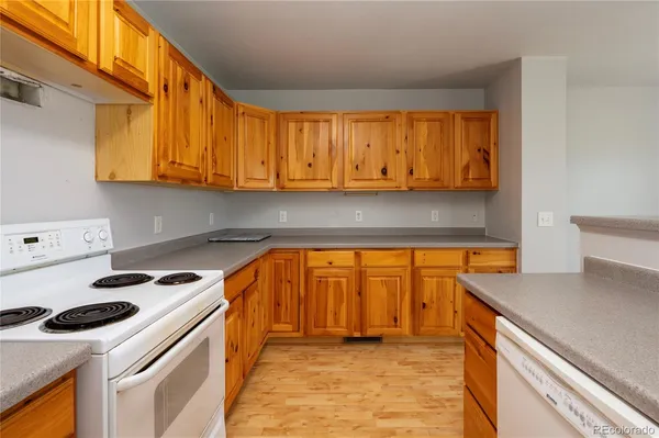 a kitchen with stainless steel appliances a stove a sink and a microwave
