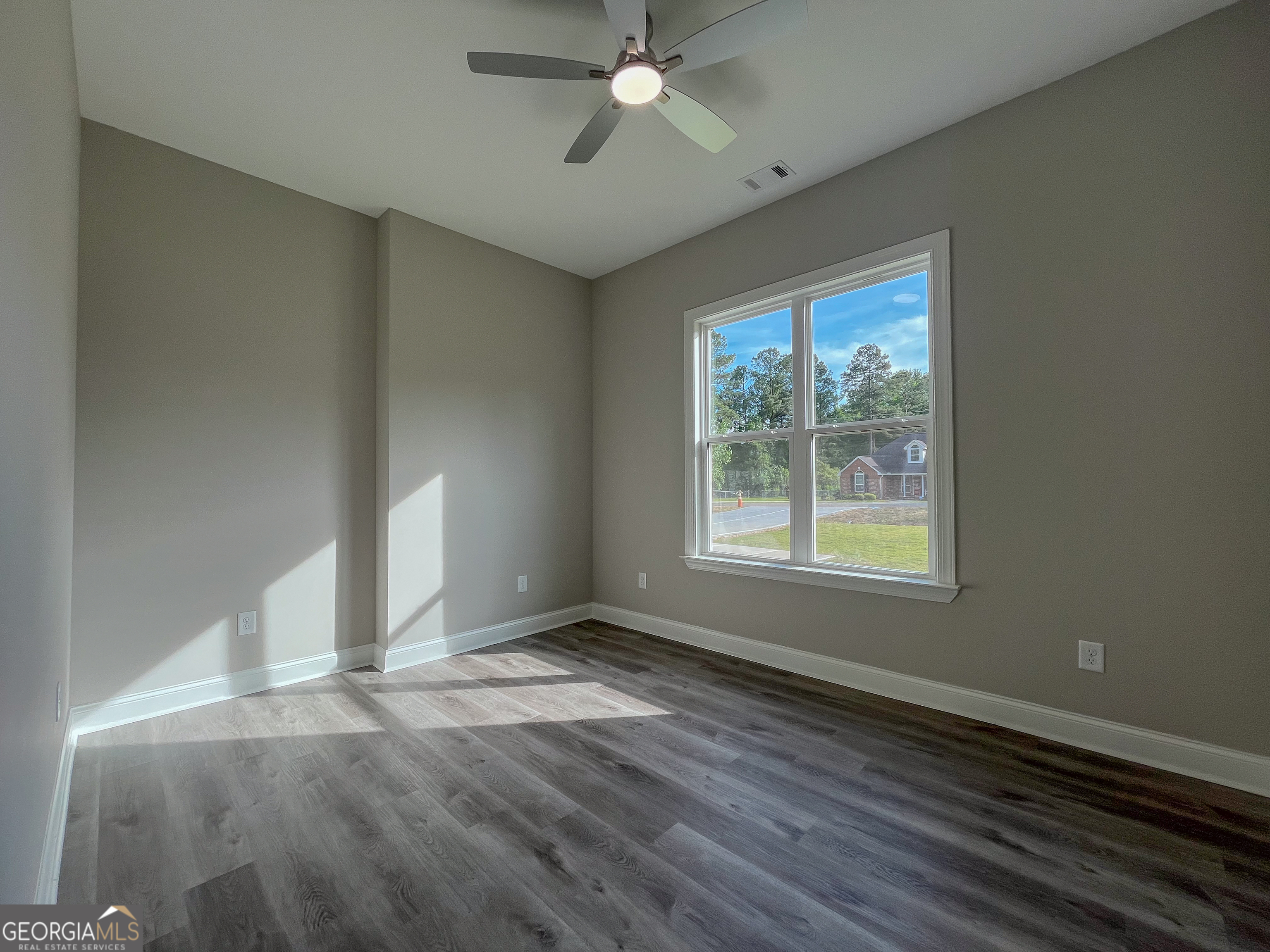 711 Flanders Lane Dublin, GA 31021 - Photo 31 of 49 wooden floor in an empty room with a window