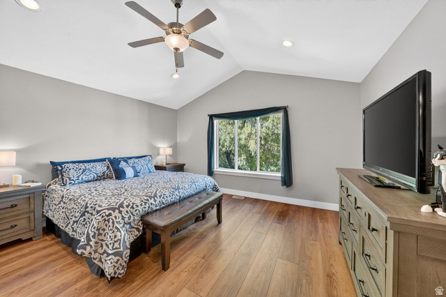 7872 Farm House Lane Midvale, UT 84047 - Photo 16 of 39 Vaulted ceiling with a ceiling fan, recessed lighting, wood-finish flooring, and a large window overlooking trees