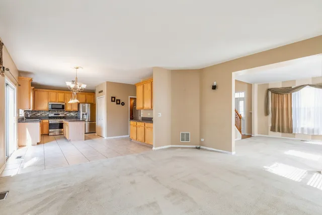 a view of a kitchen with a sink and a refrigerator