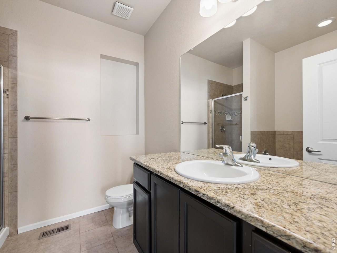 11202 Colony Circle Broomfield, CO 80021 - Photo 13 of 23 a bathroom with a granite countertop sink toilet and mirror