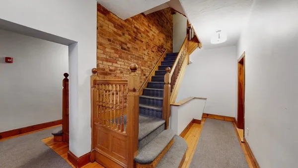 a couple of cars parked in front of a building