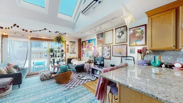 a living room with furniture and a potted plant