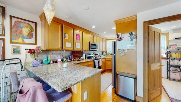 a kitchen with stainless steel appliances granite countertop a stove a sink and a refrigerator