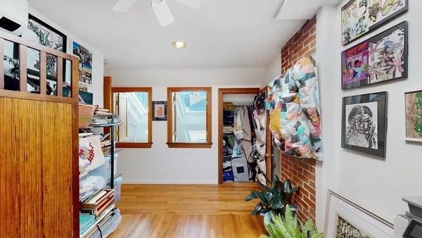 a bedroom with furniture and a flat screen tv