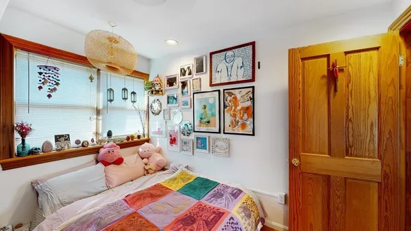 a bedroom with a bed furniture and a book shelf