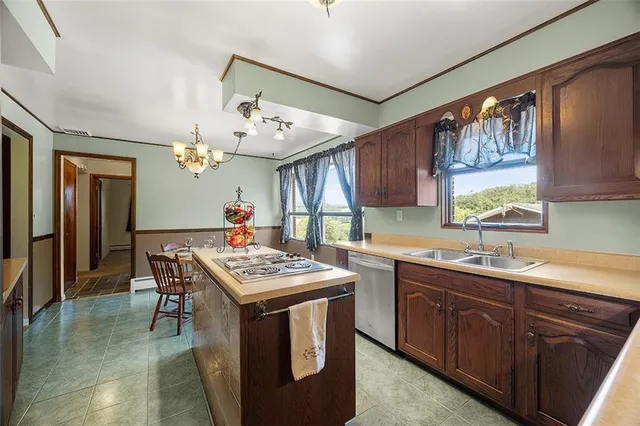 a kitchen with a sink stove and cabinets