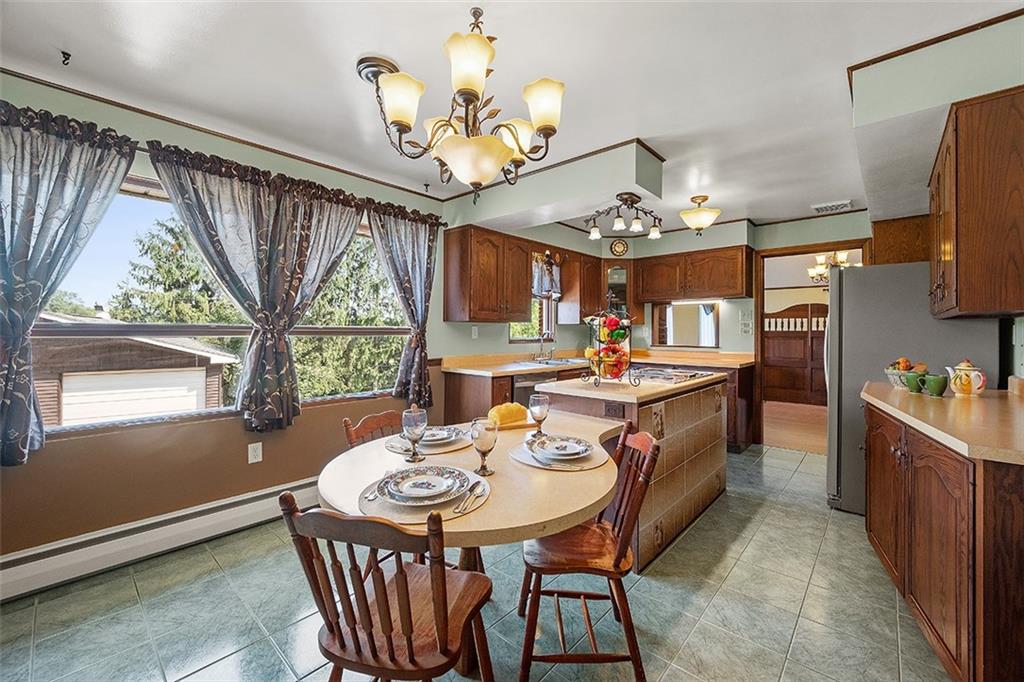 632 Sandy Hill Road Valencia, PA 16059 - Photo 13 of 48 a view of a dining room with furniture a chandelier and large windows