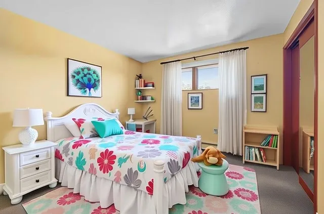 a bedroom that has a bed and a dresser in it