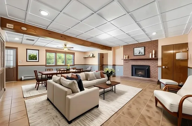 a living room with furniture and a fireplace
