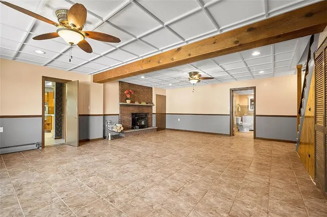 a view of a livingroom with a refrigerator and a ceiling fan