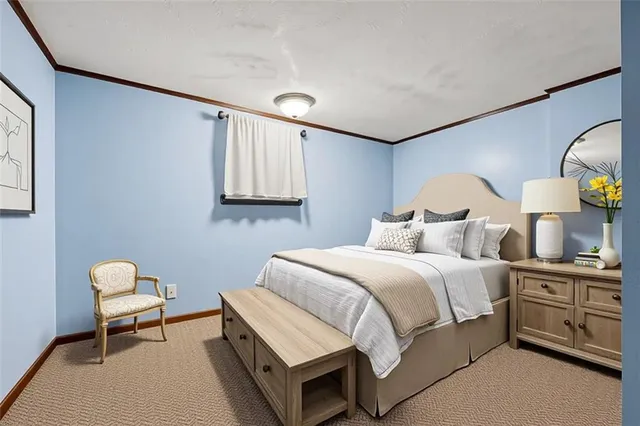 a bedroom with a bed a chair and painting on the wall