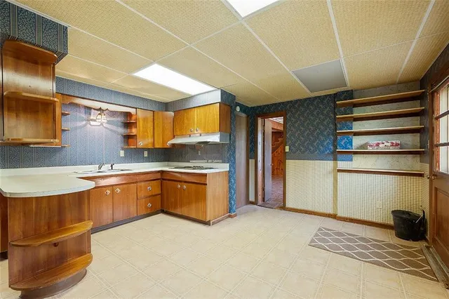 a large kitchen with stainless steel appliances granite countertop a sink and cabinets