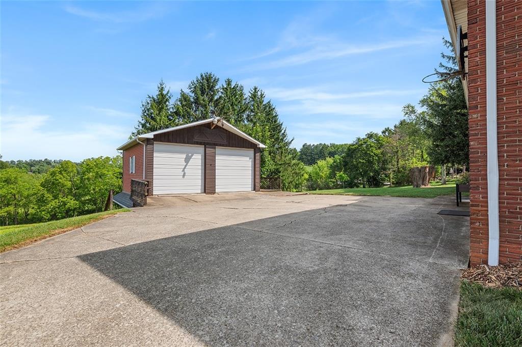 632 Sandy Hill Road Valencia, PA 16059 - Photo 44 of 48 a front view of a house with a yard and garage