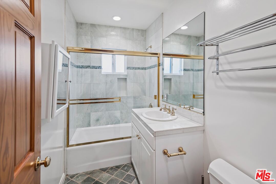 10497 Kinnard Avenue Los Angeles, CA 90024 - Photo 16 of 19 a bathroom with a sink a mirror and a shower