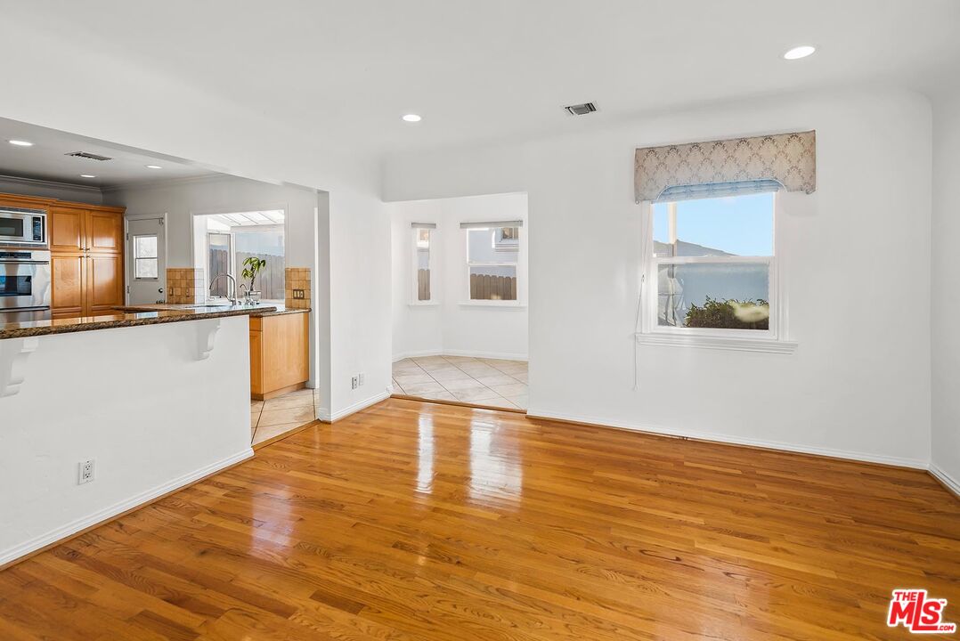 10497 Kinnard Avenue Los Angeles, CA 90024 - Photo 6 of 19 a view of a kitchen with wooden floor and a window