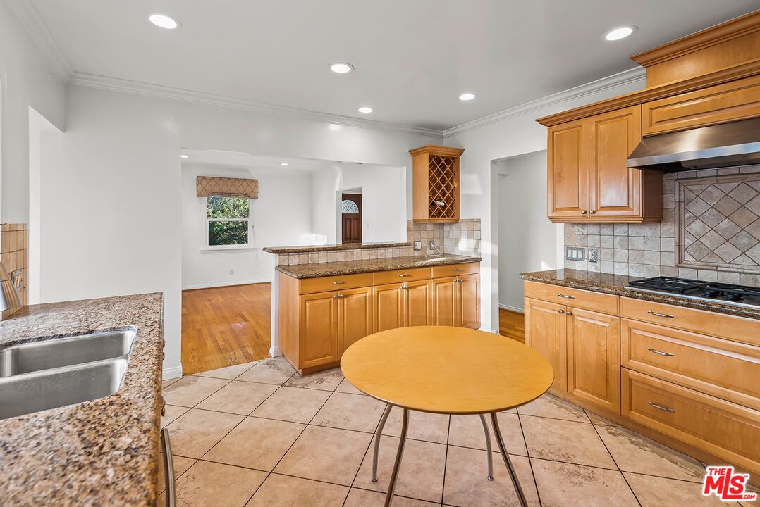 10497 Kinnard Avenue Los Angeles, CA 90024 - Photo 10 of 19 a kitchen with stainless steel appliances granite countertop a sink stove and cabinets