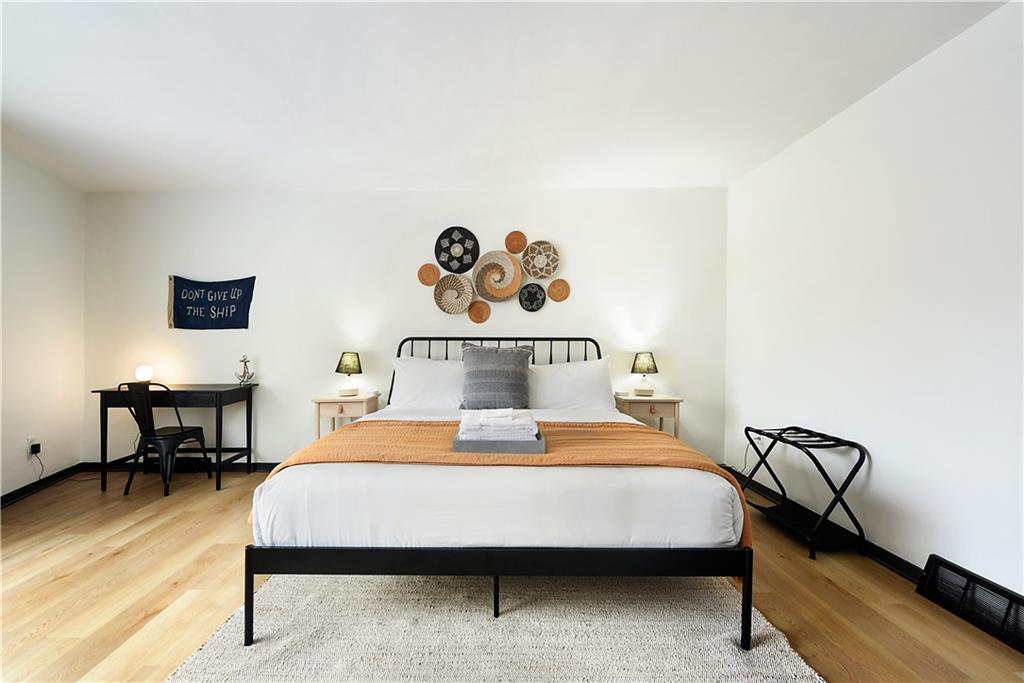 3800 Butler Street Pittsburgh, PA 15201 - Photo 11 of 21 a bedroom with a bed and a table in it