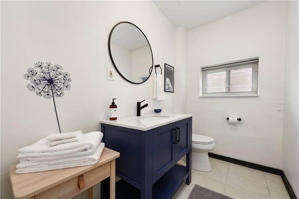 3800 Butler Street Pittsburgh, PA 15201 - Photo 14 of 21 a bathroom with a sink and a mirror