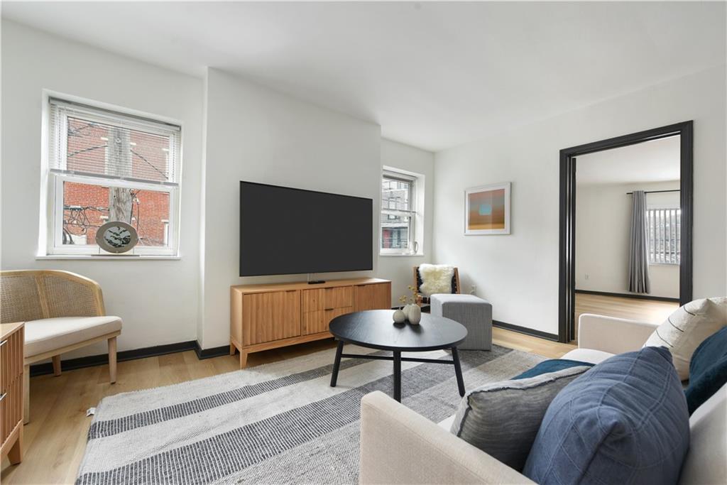 3800 Butler Street Pittsburgh, PA 15201 - Photo 4 of 21 a living room with furniture and a flat screen tv