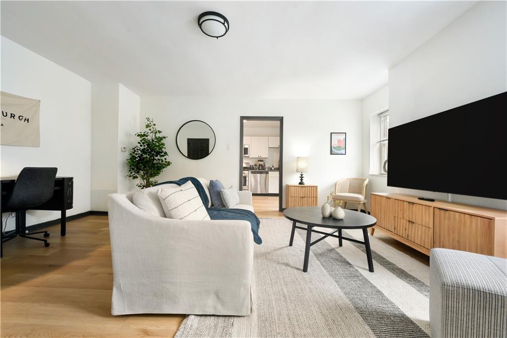 3800 Butler Street Pittsburgh, PA 15201 - Photo 6 of 21 a living room with furniture and a flat screen tv