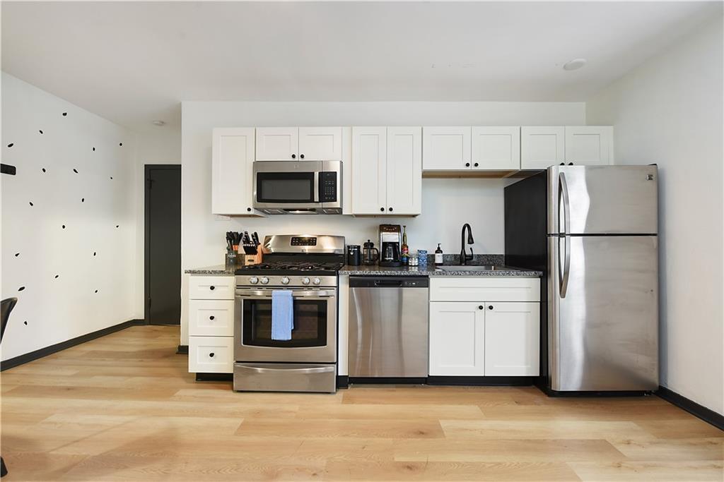3800 Butler Street Pittsburgh, PA 15201 - Photo 8 of 21 a kitchen with stainless steel appliances a refrigerator stove and microwave