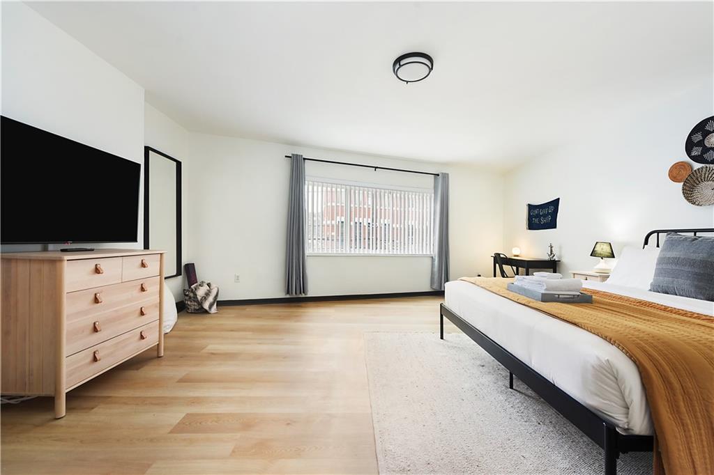 3800 Butler Street Pittsburgh, PA 15201 - Photo 10 of 21 a bedroom with a bed and a flat screen tv