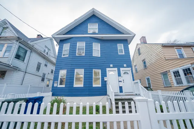 a view of a brick house with large windows
