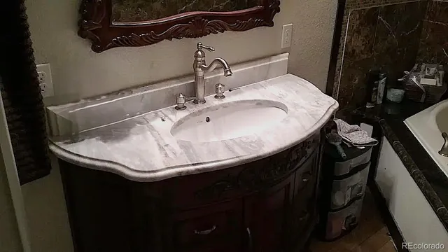 a sink sitting in a bathroom next to a sink