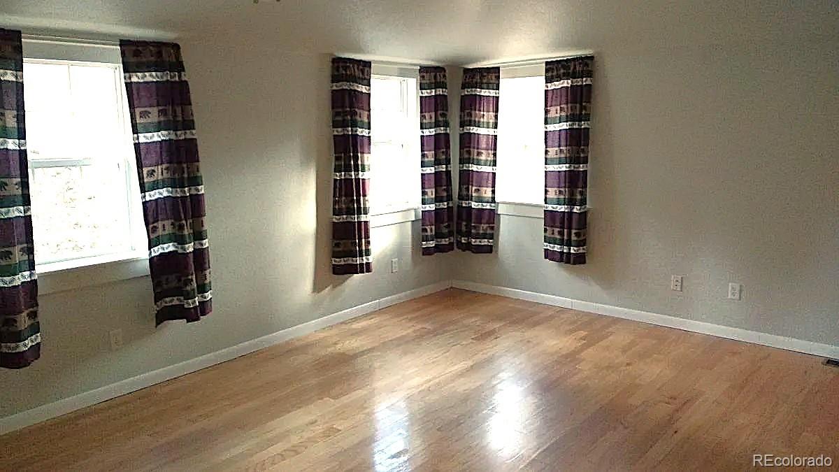 5091 South Olive Road Evergreen, CO 80439 - Photo 13 of 23 a view of wooden floor and windows in a room