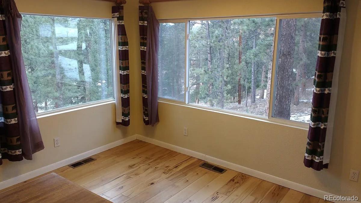 5091 South Olive Road Evergreen, CO 80439 - Photo 14 of 23 a view of a room with wooden floor and windows