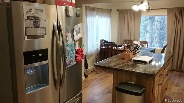 a kitchen with refrigerator and window