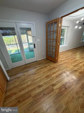a view of an empty room with a fireplace and a window