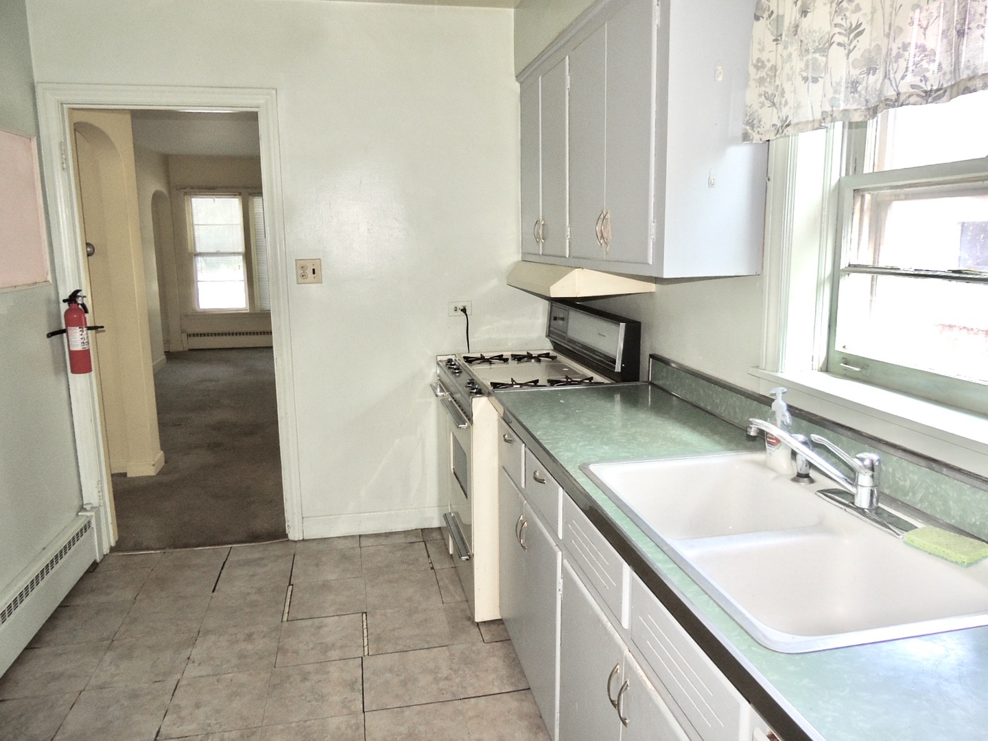 2202 River Road River Grove, IL 60171 - Photo 17 of 33 a kitchen with a sink stove and cabinets