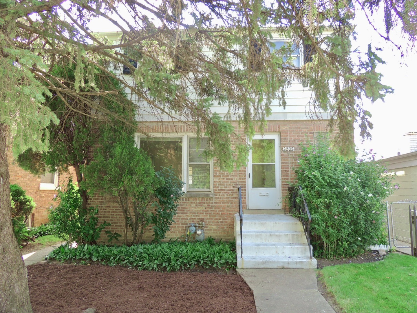 2202 River Road River Grove, IL 60171 - Photo 2 of 33 a front view of a house with garden