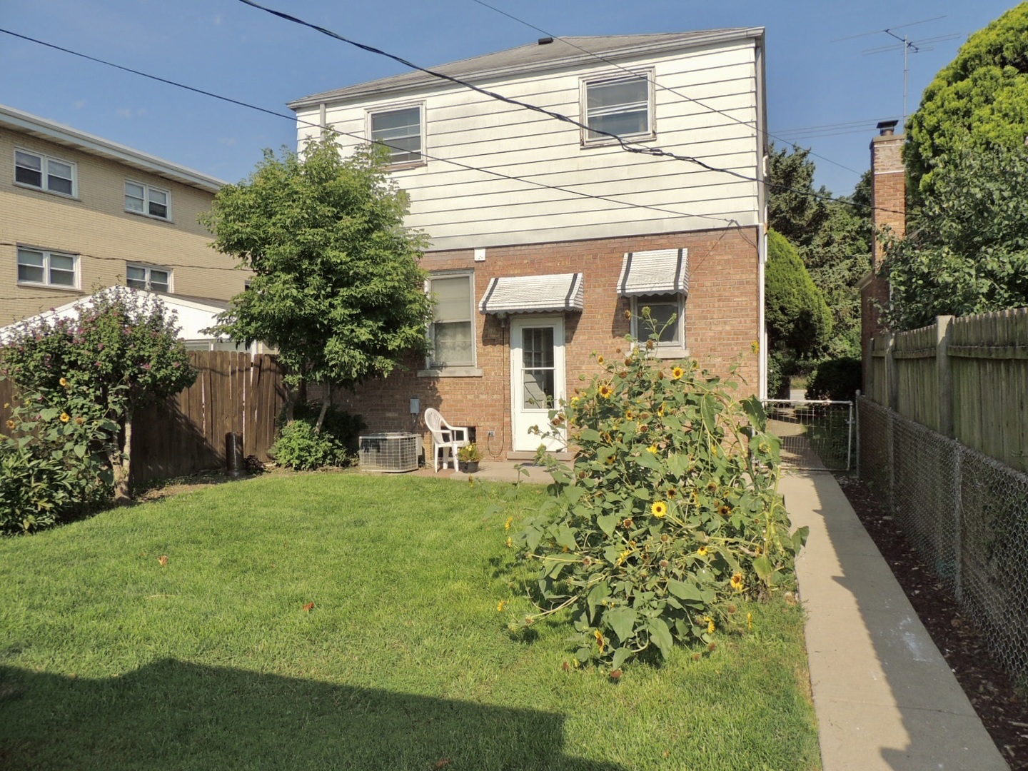 2202 River Road River Grove, IL 60171 - Photo 4 of 33 a front view of a house with a garden