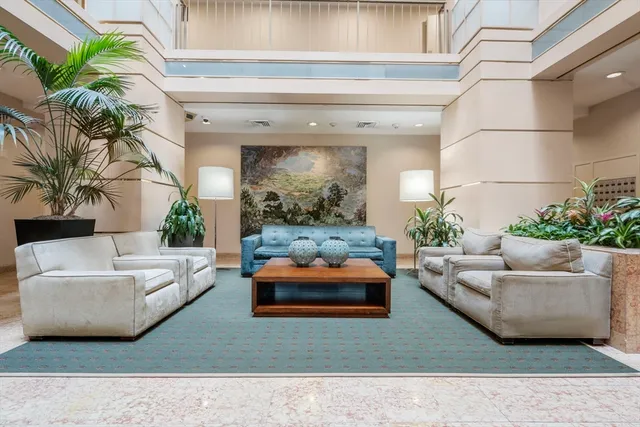 a living room with furniture and a potted plant