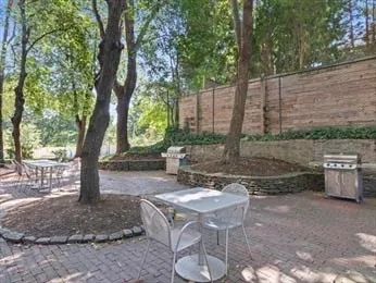 a wooden bench sitting in front of a tree