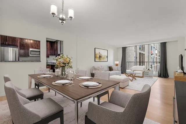 a view of a dining room with furniture and a chandelier