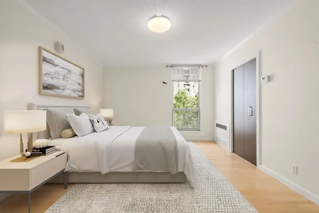 a bedroom with bed and a window